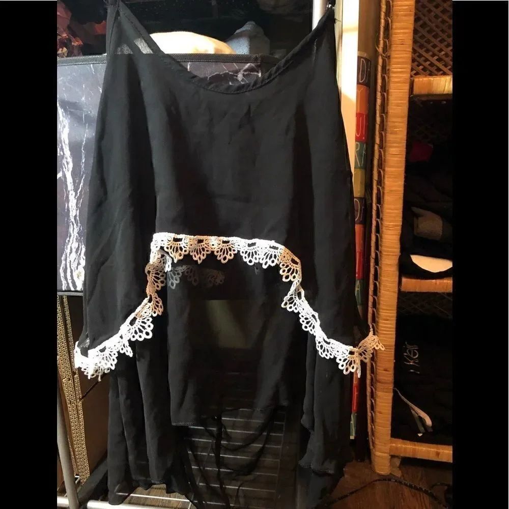 Black flutter multi layer sheer top with white embroidery trim.